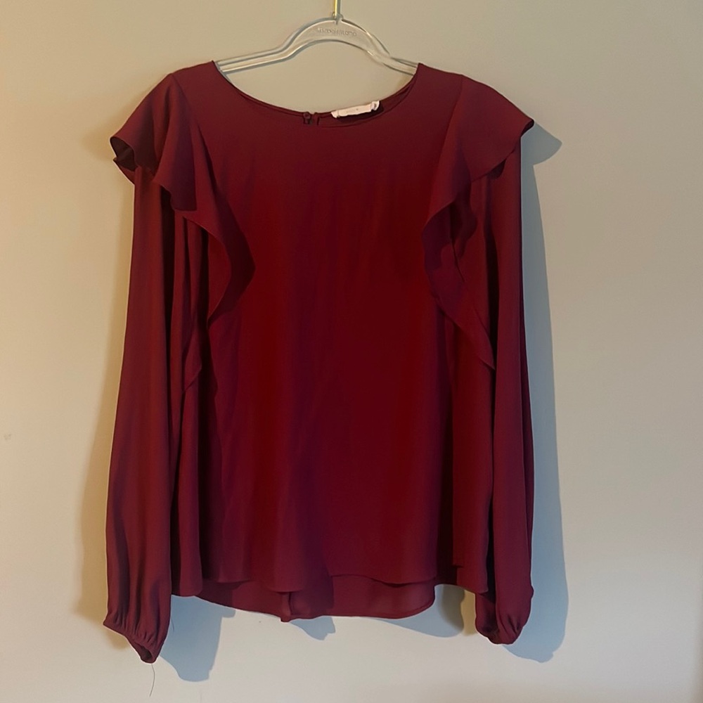 Lush burgundy top in beautiful condition with ruffled shoulders